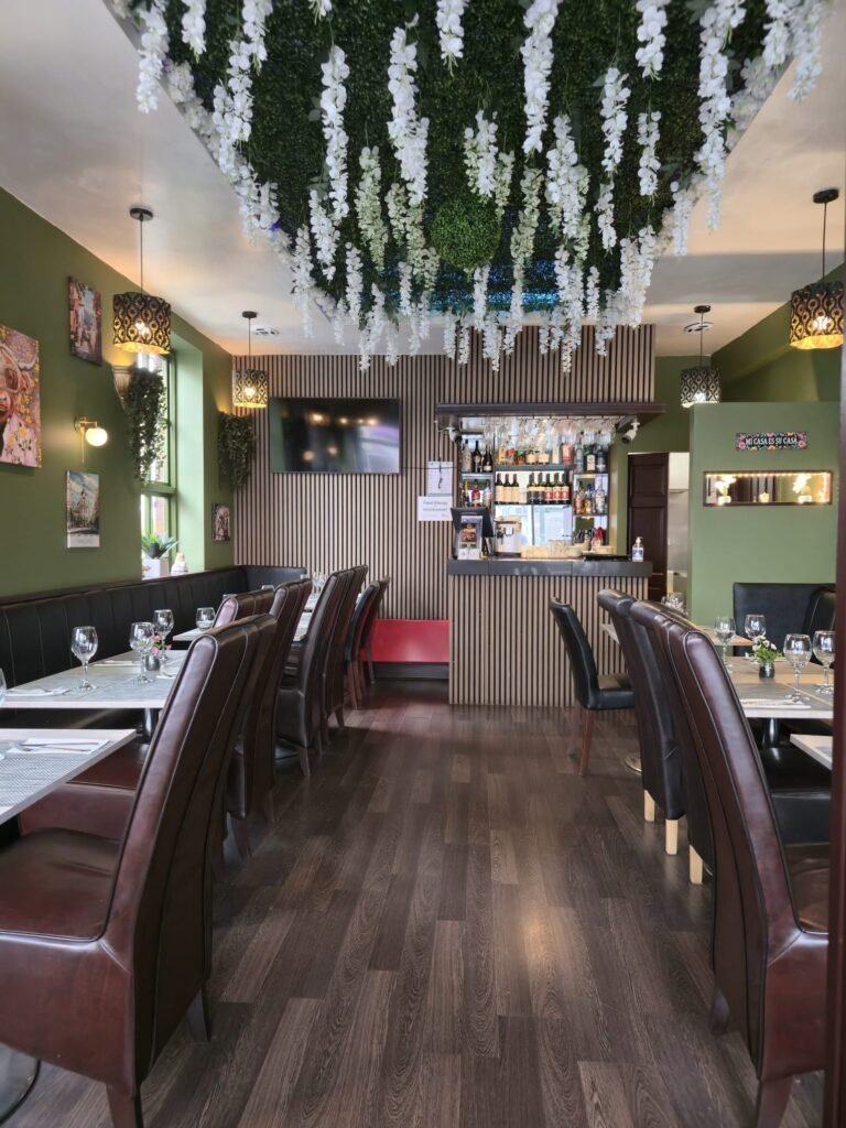 Inside Yannis & Daddy Spanish restaurant with bar and flower ceiling
