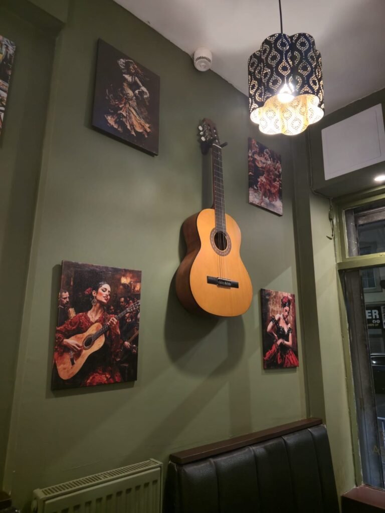 Spanish guitar and flamenco paintings on the restaurant wall