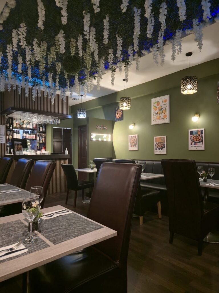 Inside Yannis & Daddy Spanish restaurant with bar and flower ceiling
